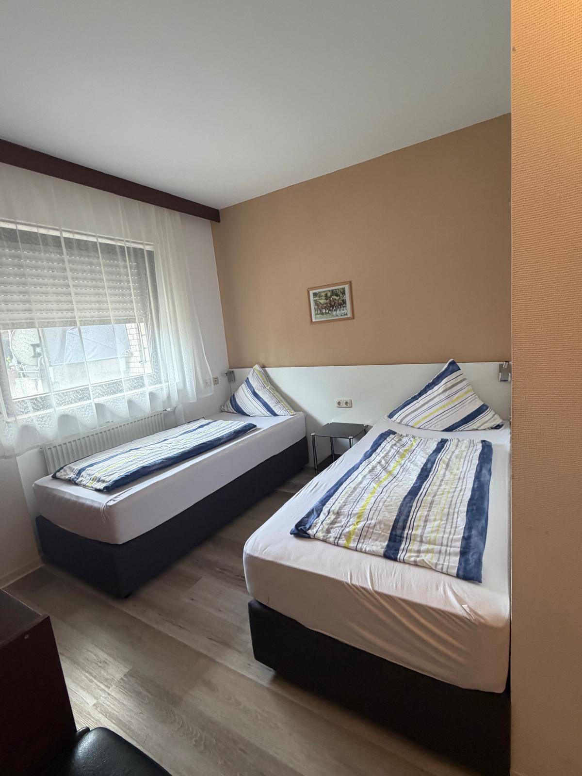 Doppelzimmer mit Doppel- und Mehrbettzimmer verfügbar und modernes Bad im Zimmer im Hotel-Pension Weller Mühlheim in Mühlheim am Main – ab 75 € pro Nacht